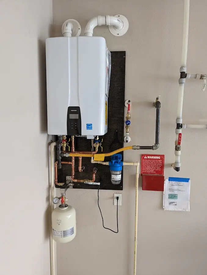 Professional plumber installing copper piping in a Holly Hill home